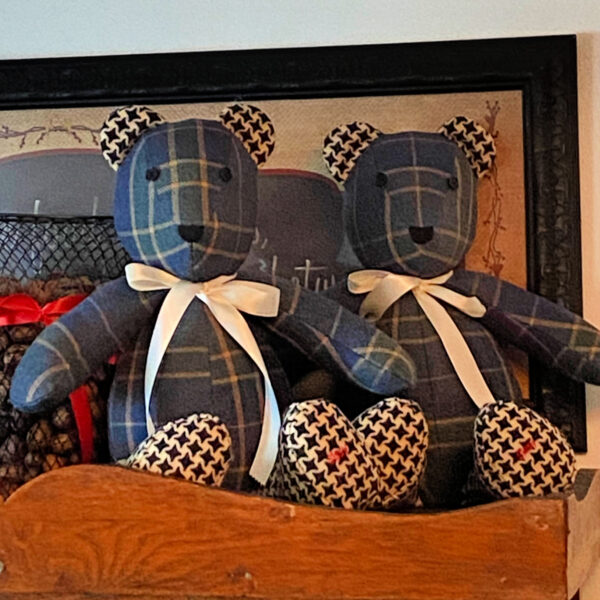 Blue and Green Plaid Flannel Bears sit atop a cabinet. Each has a cream colored ribbon and ears and feet of contrasting fabric.